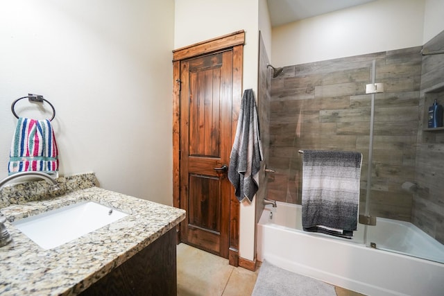 bathroom featuring tile patterned floors, vanity, and bath / shower combo with glass door