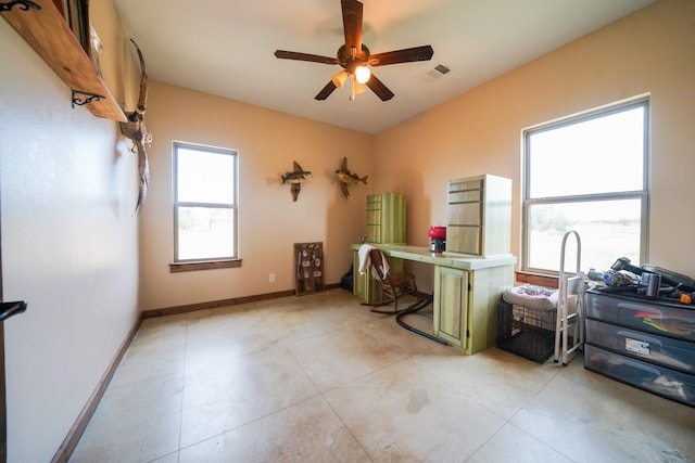 interior space with ceiling fan