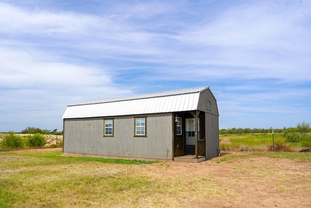 view of outbuilding featuring a lawn