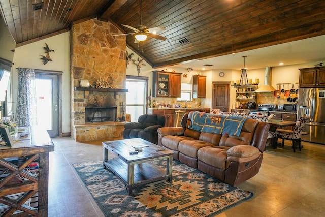 living room with high vaulted ceiling, wooden ceiling, beamed ceiling, ceiling fan, and a fireplace