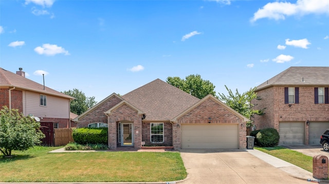 view of front property featuring a garage and a front lawn