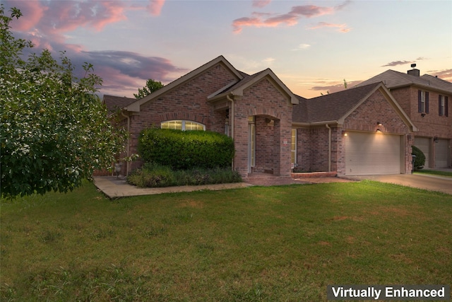 view of front of home featuring a garage, a front yard, brick siding, and driveway