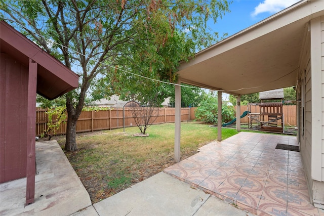 view of yard with a playground, a patio area, and a fenced backyard