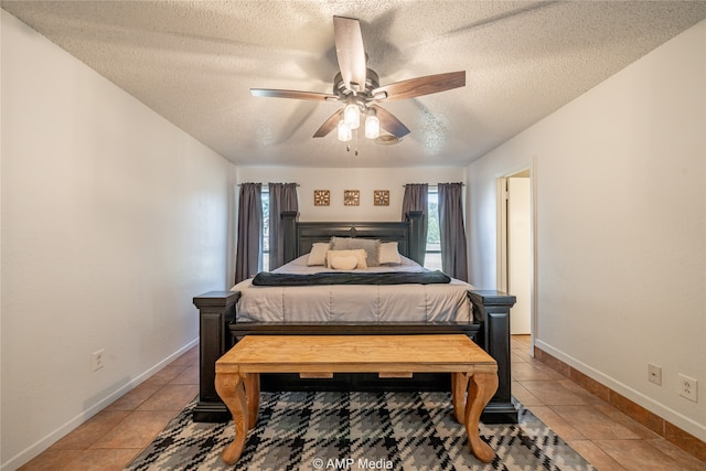 tiled bedroom featuring a textured ceiling and ceiling fan