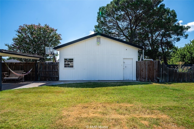 view of side of property with a lawn and fence