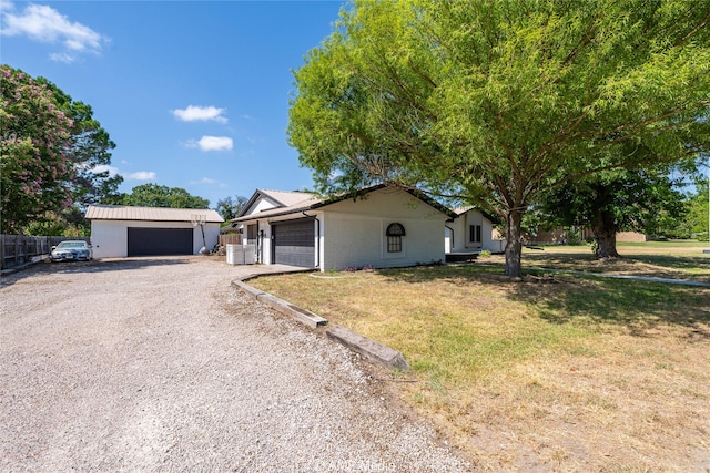 single story home with a garage, fence, driveway, and a front lawn