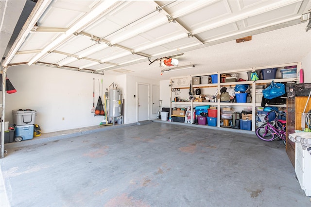 garage featuring water heater and a garage door opener