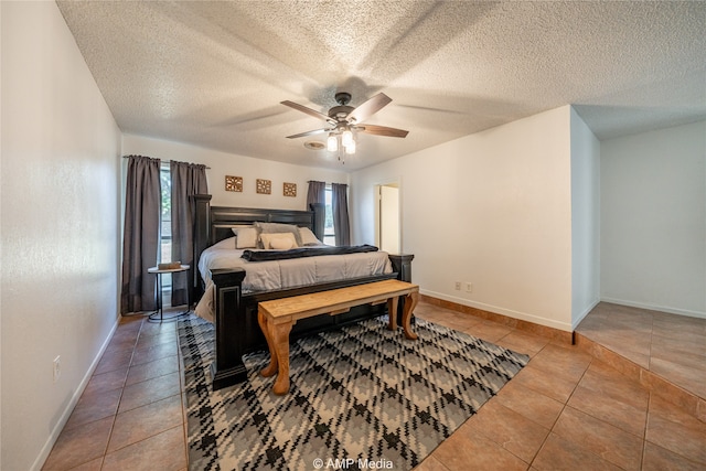 bedroom with a textured ceiling, light tile patterned floors, and ceiling fan