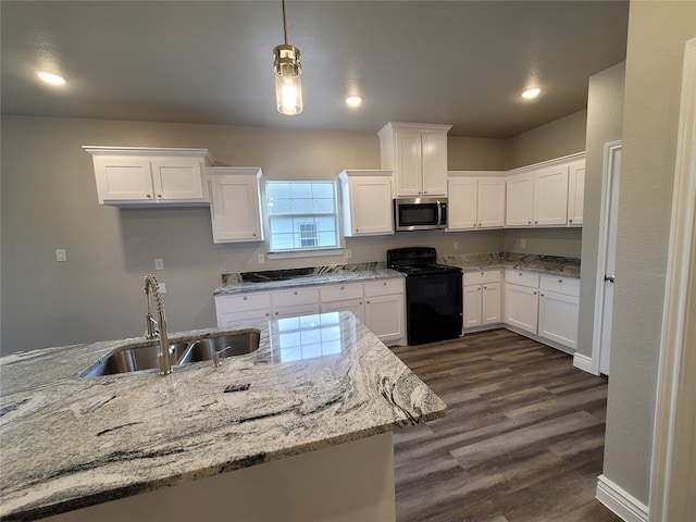 kitchen with light stone counters, sink, electric range, white cabinets, and dark hardwood / wood-style floors