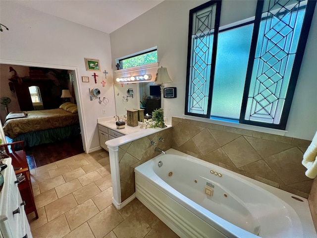 bathroom with vanity, tile patterned floors, and a bath