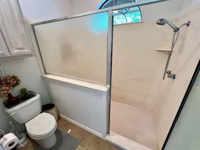 bathroom featuring toilet and walk in shower