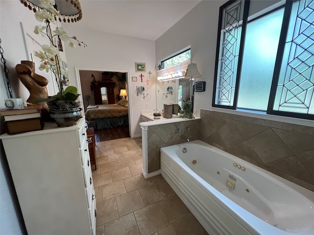 bathroom with tile patterned floors and a bath