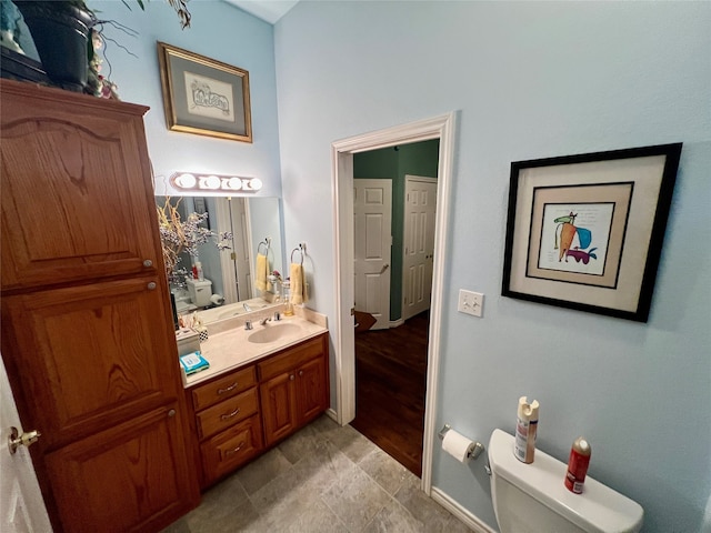 bathroom featuring vanity, hardwood / wood-style floors, and toilet