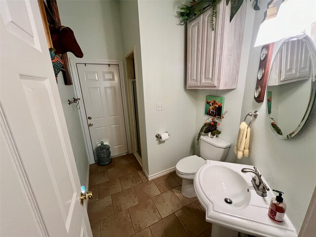 bathroom with tile patterned floors, sink, and toilet