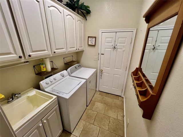 washroom with cabinets, washer and dryer, sink, and light tile patterned floors