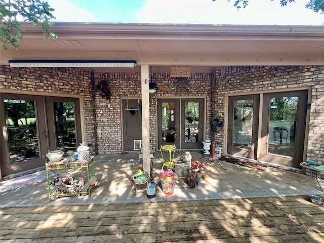 view of exterior entry featuring a wooden deck and french doors