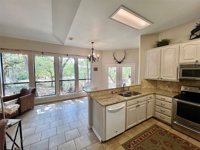 kitchen featuring sink, appliances with stainless steel finishes, and a healthy amount of sunlight