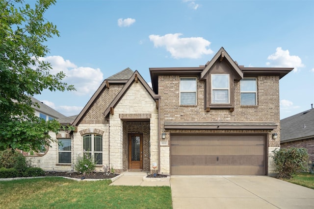 view of front of house with a garage and a front lawn