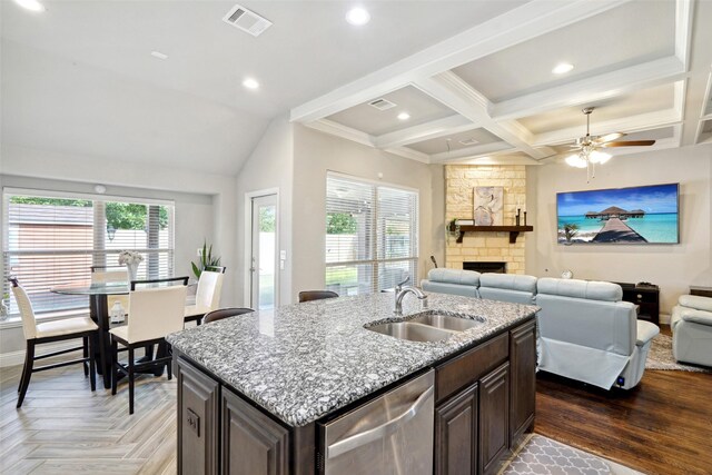 kitchen with dishwasher, a kitchen island with sink, ceiling fan, coffered ceiling, and sink