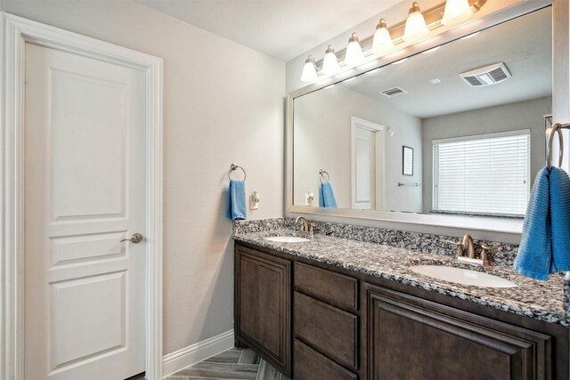 bathroom with dual vanity