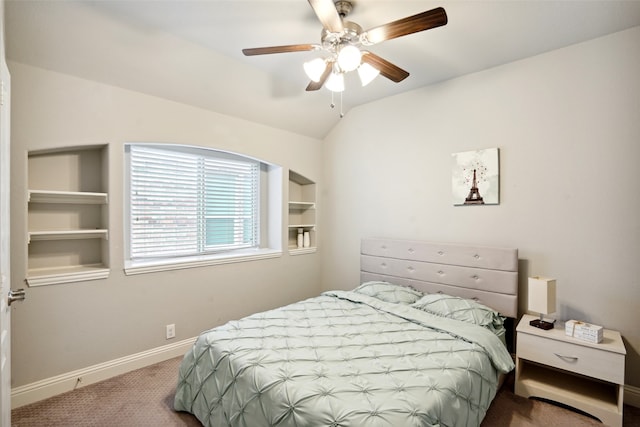 carpeted bedroom with vaulted ceiling and ceiling fan