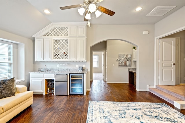 kitchen featuring fridge, light stone countertops, dark wood-type flooring, beverage cooler, and ceiling fan