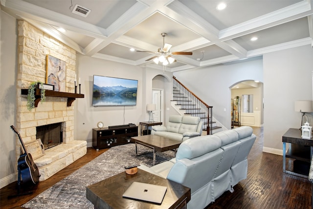 living room featuring coffered ceiling, a fireplace, ceiling fan, and dark hardwood / wood-style floors