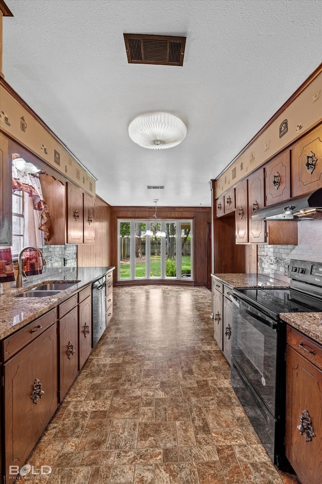 kitchen with a textured ceiling, black / electric stove, sink, light stone counters, and stainless steel dishwasher