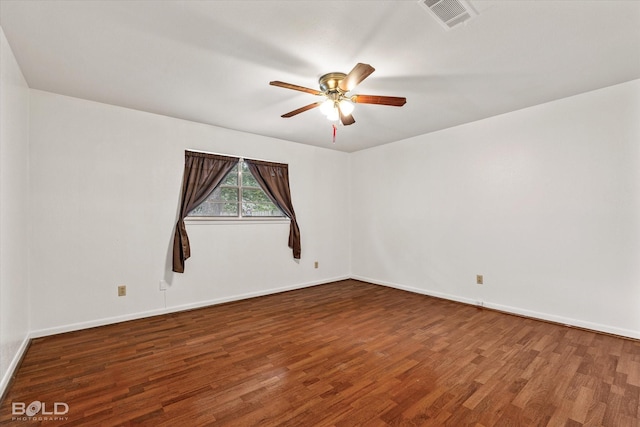 spare room featuring ceiling fan and dark hardwood / wood-style floors