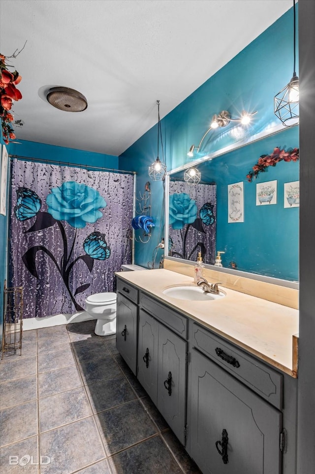 bathroom featuring vanity, toilet, and walk in shower