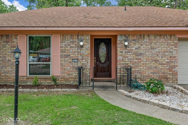 doorway to property with a lawn