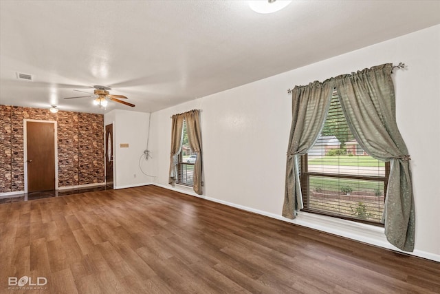 empty room with ceiling fan and wood-type flooring