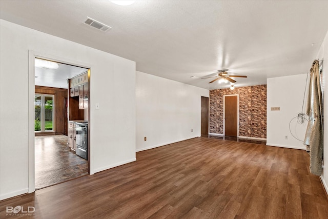 unfurnished living room with a textured ceiling, ceiling fan, and dark hardwood / wood-style flooring