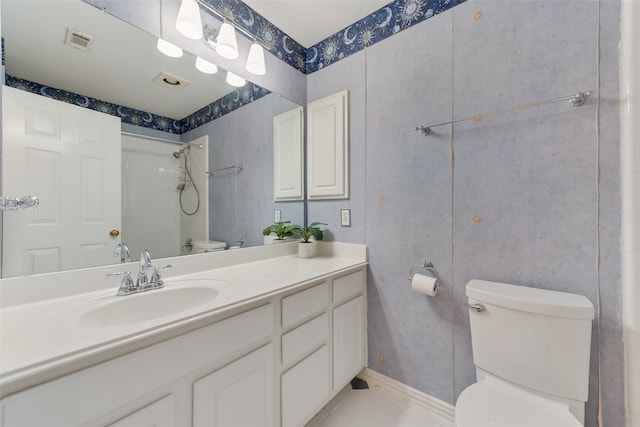 bathroom featuring vanity, tile patterned flooring, and toilet