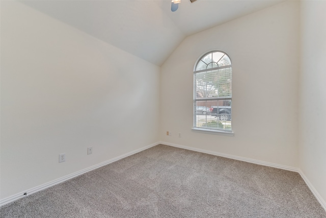 unfurnished room with lofted ceiling and carpet floors