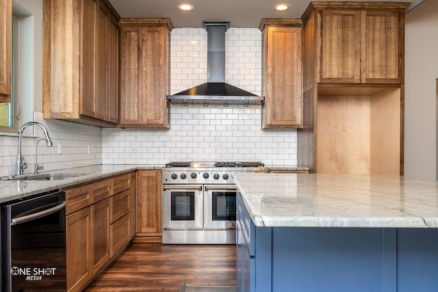 kitchen with decorative backsplash, wall chimney exhaust hood, sink, range with two ovens, and black dishwasher