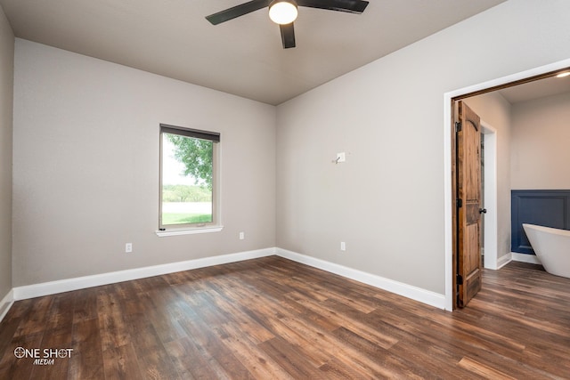 empty room featuring dark hardwood / wood-style flooring and ceiling fan