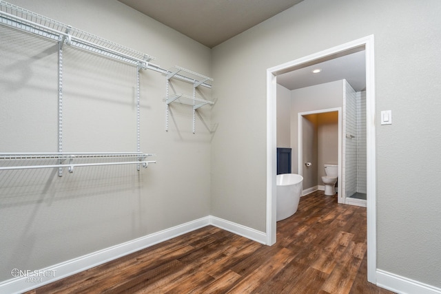 walk in closet featuring dark wood-type flooring