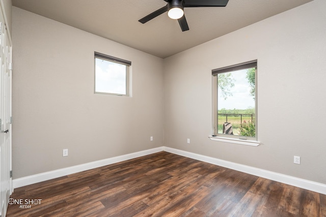 empty room featuring dark hardwood / wood-style flooring, ceiling fan, and a healthy amount of sunlight