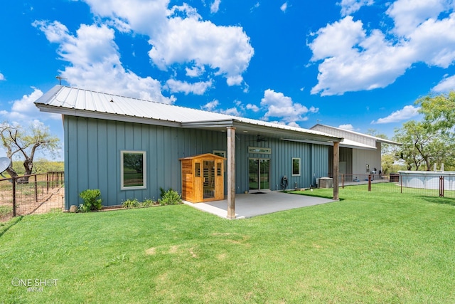 rear view of property featuring a patio area and a yard