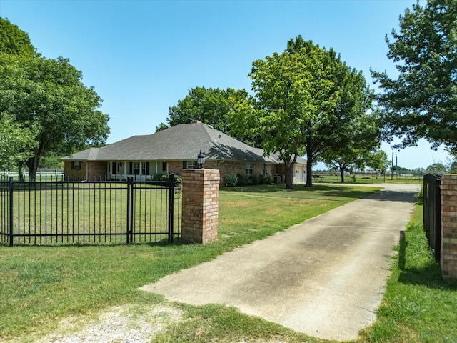 view of gate featuring a lawn