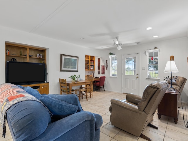 tiled living room with built in shelves and ceiling fan