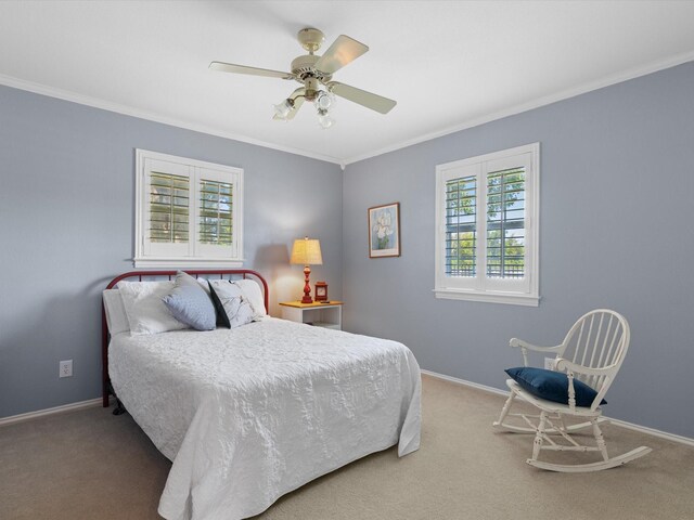 carpeted bedroom featuring ceiling fan and ornamental molding