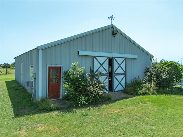 view of outbuilding with a yard