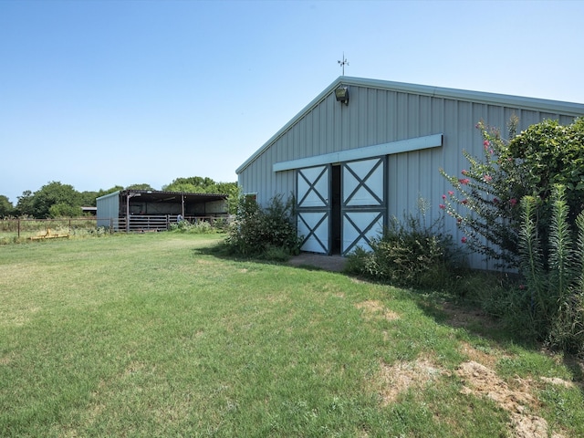 view of outdoor structure featuring a lawn