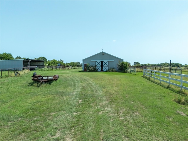 view of yard featuring an outbuilding and a rural view