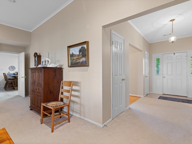 foyer entrance featuring light carpet and ornamental molding