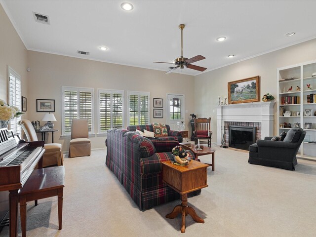 living room featuring ornamental molding, light carpet, a fireplace, and ceiling fan