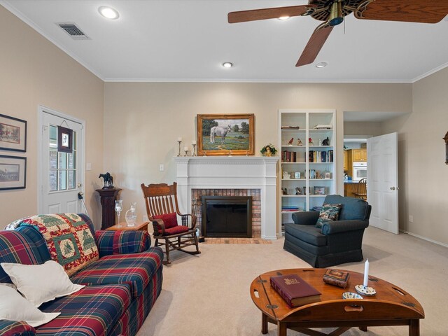 carpeted living room featuring a fireplace, crown molding, and ceiling fan