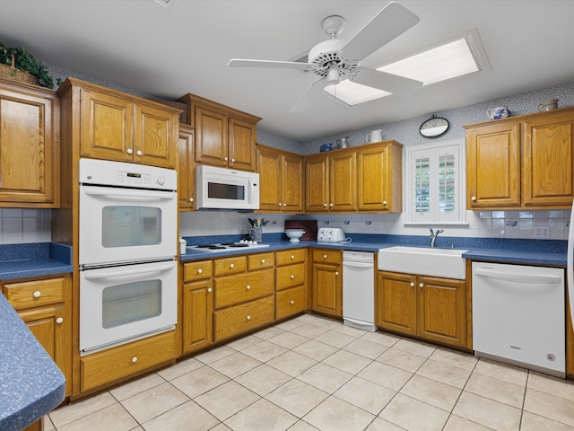 kitchen featuring light tile patterned floors, tasteful backsplash, ceiling fan, and white appliances